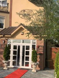 a house with a red carpet in front of a door at Casa Rosa by MANAGR in Piatra Neamţ