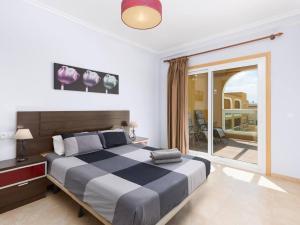 a bedroom with a large bed and a large window at My little paradise in Cotillo