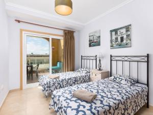 a bedroom with two beds and a balcony at My little paradise in Cotillo