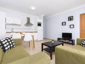 a living room with two couches and a table at My little paradise in Cotillo +23 photos