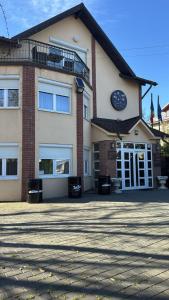 a building with a clock on the front of it at Casa Rosa by MANAGR in Piatra Neamţ