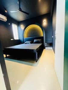 a bedroom with a bed with a yellow and blue wall at Khokhar studio in Karnal