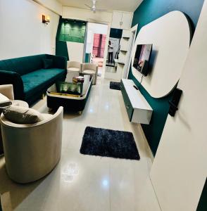 a living room with a couch and a tv at Khokhar studio in Karnal