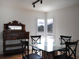 a dining room with a glass table and chairs at LAIDA BEACH by Urdaibai Experience in Ibarrangelu