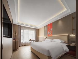 Ένα ή περισσότερα κρεβάτια σε δωμάτιο στο Yicheng Hotel Guilin Liangjiang Sihu East-West Alley Branch +18 φωτογραφίες