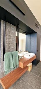 a bathroom with a sink and a mirror at Le Domaine des Manguiers in Saint-Gilles les Bains