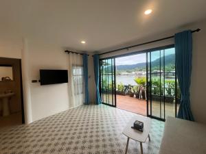 a hotel room with a view of a balcony at Baan Purada in Ko Lanta