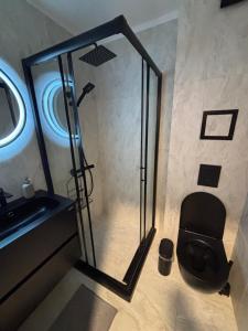 a bathroom with a shower with a toilet and a sink at Ski-in Flat Next to Ski Road at Mountain View in Bansko