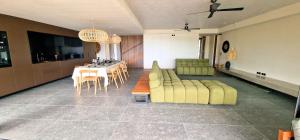 a living room with a couch and a table at Le Domaine des Manguiers in Saint-Gilles les Bains