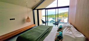 a bedroom with a bed and a large window at Le Domaine des Manguiers in Saint-Gilles les Bains +46 photos