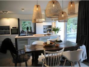 a kitchen with a dining room table and chairs at N7Quartier in Bad Münstereifel +21 photos