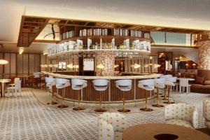 een restaurant met een bar met witte krukken bij Sheraton Stockholm Hotel in Stockholm