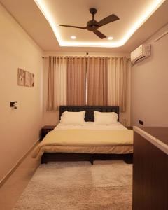a bedroom with a bed with a ceiling fan at Narayani Villa in Udaipur +19 photos