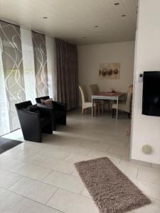 a living room with a couch and a table at Ferienhaus 251 in Burhave in Burhave