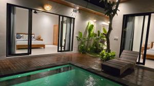 a room with a swimming pool and a bedroom at Adyatma Ubud in Ubud
