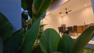 Una sala de estar con una mesa y una planta. en Adyatma Ubud, en Ubud