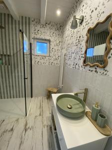 a bathroom with a sink and a glass shower at Skryta Chata Ojców in Smardzowice +3 photos