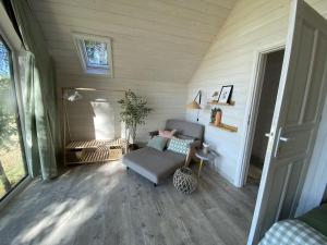 a living room with a couch and a table at Skryta Chata Ojców in Smardzowice