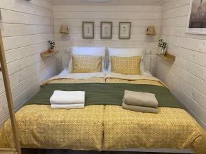 a bedroom with a large bed with two pillows at Skryta Chata Ojców in Smardzowice