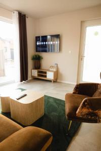 a living room with a couch and a coffee table at Maison MUGUET 3 SPA-PARKING-COLMAR in Wickerschwihr