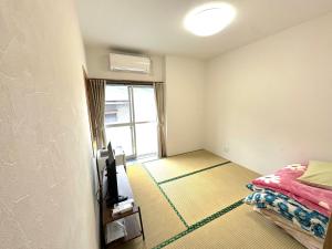 Postel nebo postele na pokoji v ubytování 徳之島体験お宿結屋