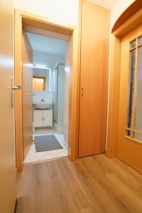 a hallway with a bathroom with a sink and a door at Relax 6 in Hahnenklee-Bockswiese