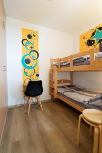 a bedroom with two bunk beds and a chair at Relax 6 in Hahnenklee-Bockswiese