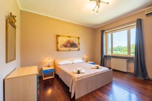 a bedroom with a bed and a large window at Villa with Pool in Unesco, 4 Room, Parking e Free WiFi in San Damiano dʼAsti +61 photos