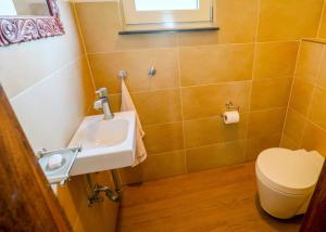 a bathroom with a sink and a toilet at Gin Villa in Kammala South