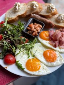 a plate of eggs and toast and other foods at Красник Хілс in Krasnik