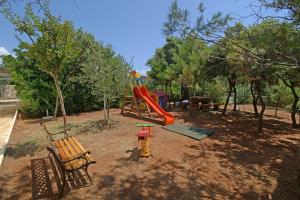 a playground with a slide and a swing set at Apartments by the sea Mandre, Pag - 12567 in Mandre