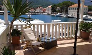 a chair and a table on a balcony with a marina at Seaside apartments with a swimming pool Jelsa, Hvar - 2067 in Jelsa
