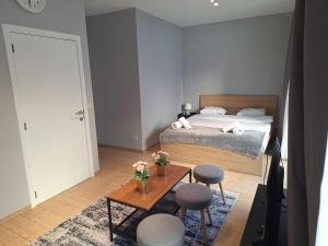 a bedroom with a bed and a table with chairs at Résidence des sables in Brussels