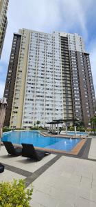 a large apartment building with a large swimming pool at Vinyce Studio in Cagayan de Oro