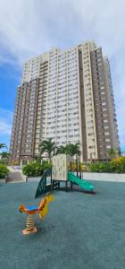 a playground in front of a large apartment building at Vinyce Studio in Cagayan de Oro