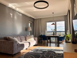 a living room with a couch and a table at Sen Krasnala by FuzjaAparts in Wrocław