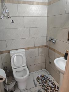 a bathroom with a toilet and a sink at Gcm 3 rooms kentro κατερινη in Katerini