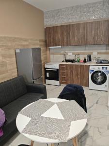 a living room with a table and a kitchen at Gcm 3 rooms kentro κατερινη in Katerini