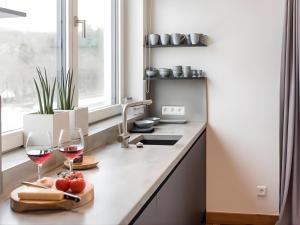 a kitchen with two glasses of wine on a counter at N8Quartier Eifel in Bad Münstereifel