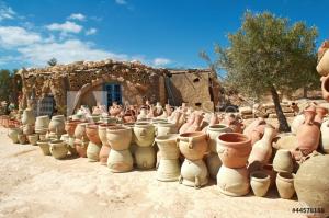 a group of pottery pots sitting in front of a building at trip to djerba in Djerba