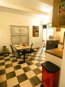 a kitchen with a table and chairs in a room at Au Bal des Oiseaux in Chavagnes-en-Paillers