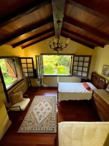 a bedroom with two beds and a chandelier at Spacious Villa with Pool in Cabeanca 250 m² in Ourense