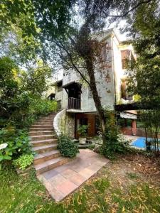 a house with a staircase leading up to a house at Spacious Villa with Pool in Cabeanca 250 m² in Ourense