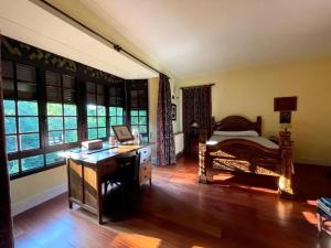 a bedroom with a desk and a bed and windows at Spacious Villa with Pool in Cabeanca 250 m² in Ourense +41 photos