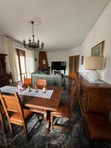 a living room with a table and a couch at Tuscany Hills Penthouse in Fivizzano +19 photos