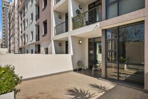an apartment building with a balcony and a patio at Easy Stay - The Vantage Rosebank in Johannesburg