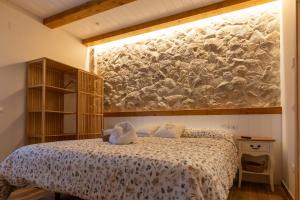 a bedroom with a bed and a large painting on the wall at Casa Teresa in La Santa Espina