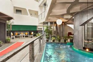 a lobby with a swimming pool in a building at Afallon Hotels in Bangalore