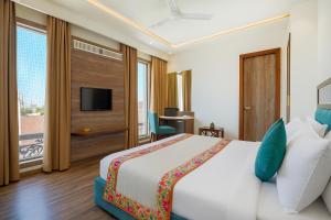 um quarto de hotel com uma cama e uma televisão em Hotel Comfort view em Amritsar
