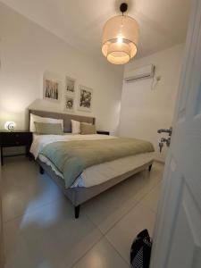 a bedroom with a large bed with a light at So Chic Family Villa in Flic-en-Flac